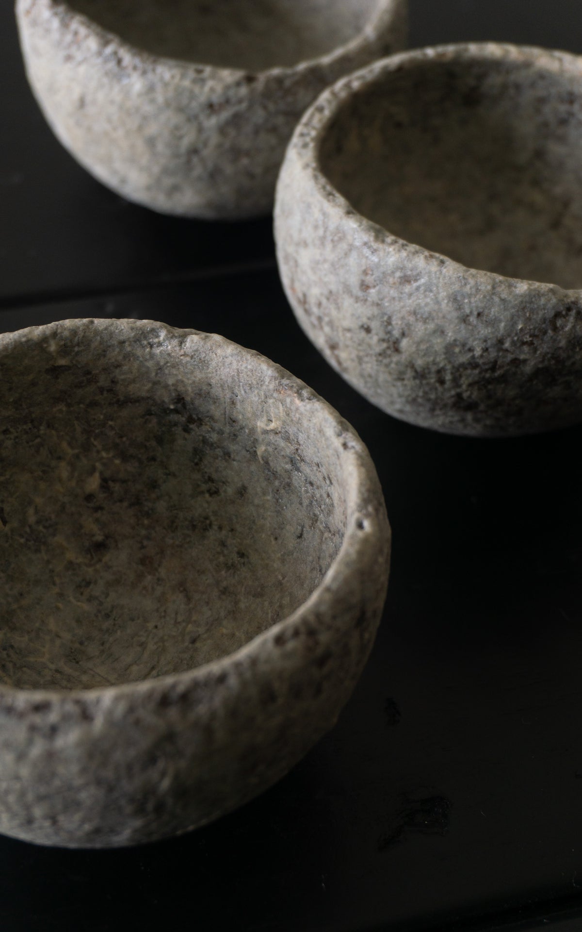 Three ceramics bowls on a dark wooden table
