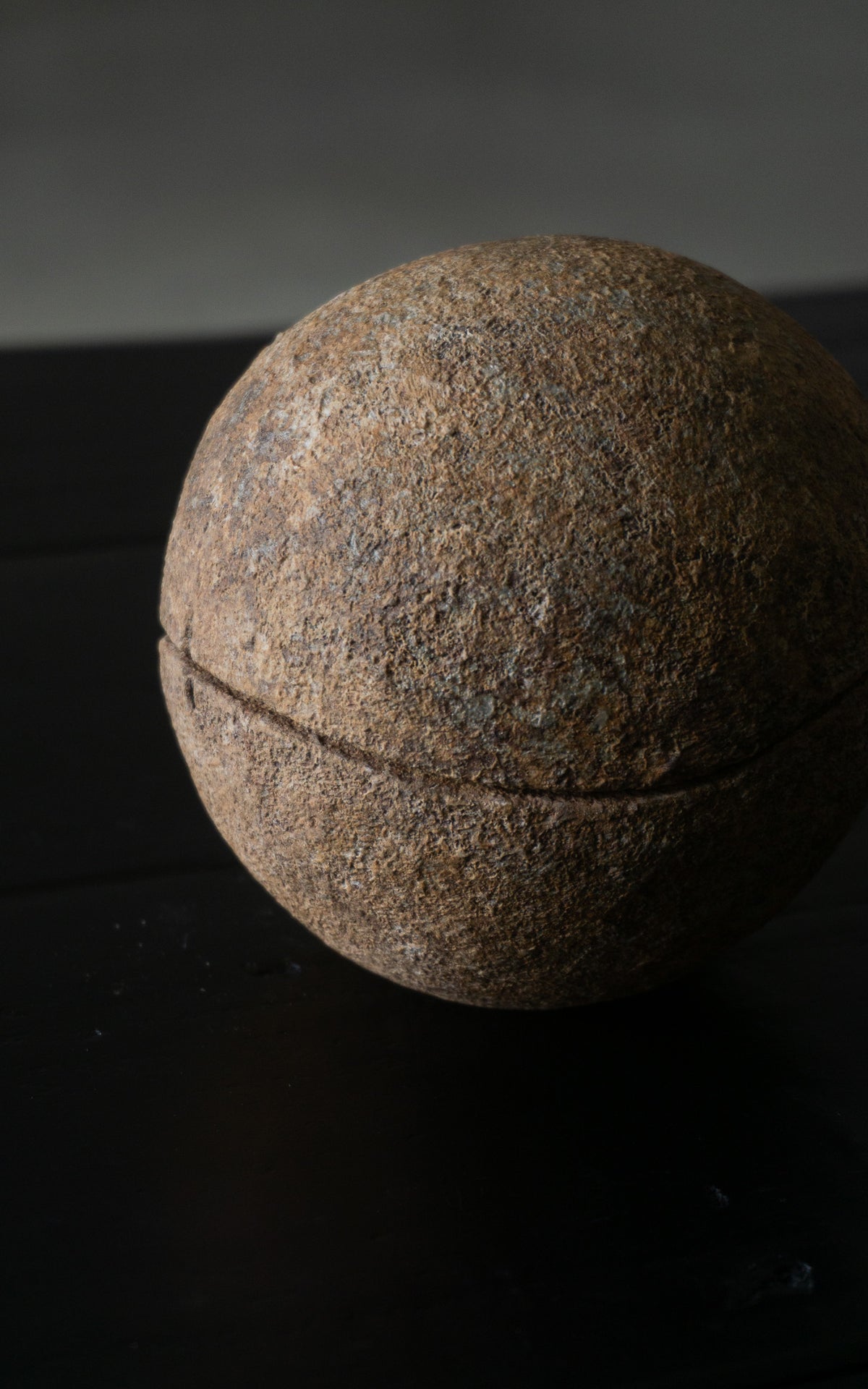 Close-up of textured ceramic sphere bowls on a dark background