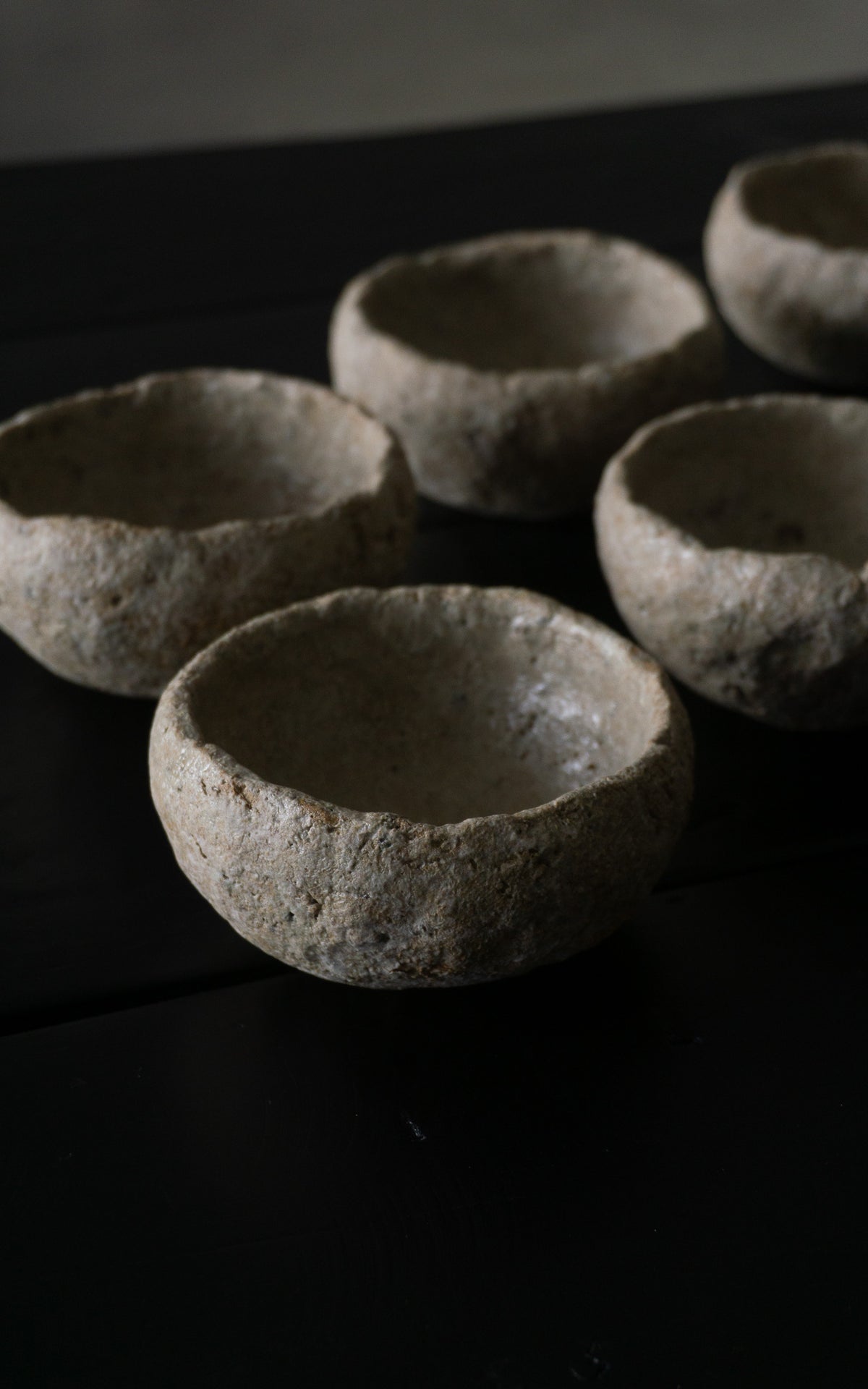Set of small ceramic bowls on a dark surface